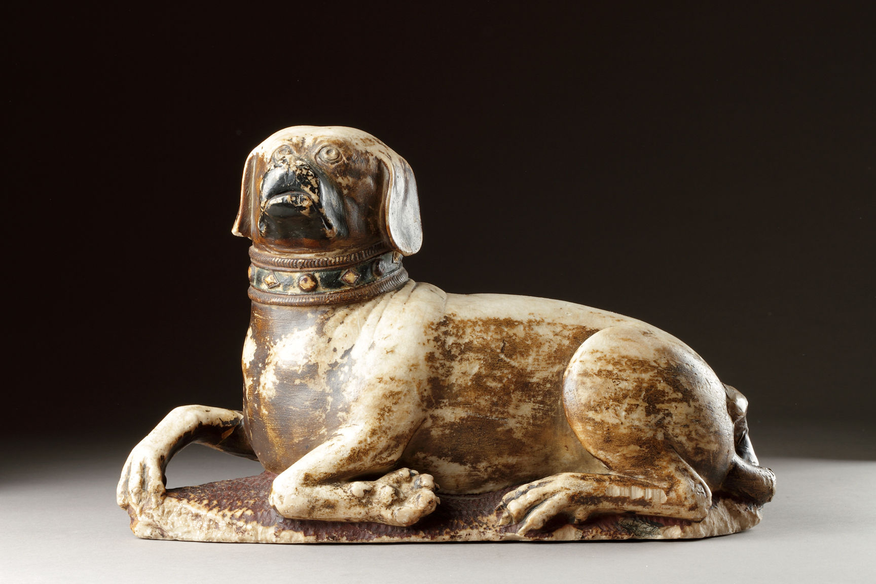 Very Rare Medieval English Alabaster Tomb Sculpture of a Hound Dog Seated on a Carved Mail Ground